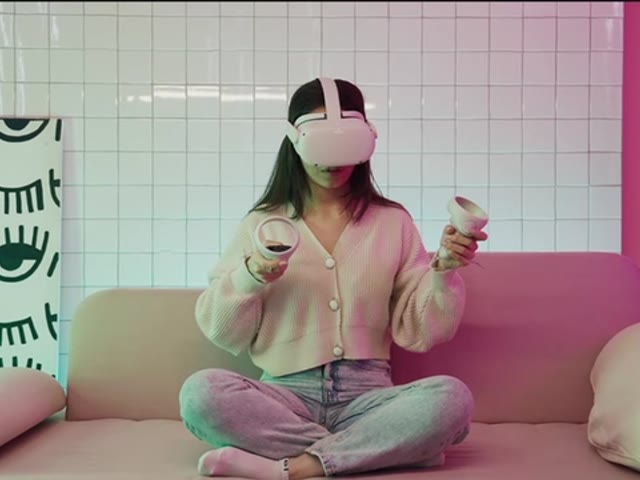 Person using a virtual-reality headset and handheld controllers