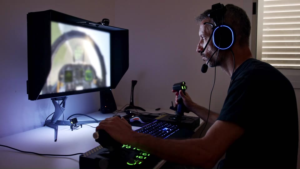 Operator monitoring a live camera feed from a control station